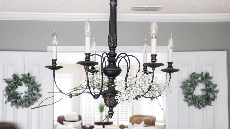 Add a second bundle of flowers to the next arm on the chandelier.