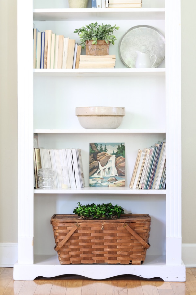 Decorating a bookcase with a wicker picnic basket