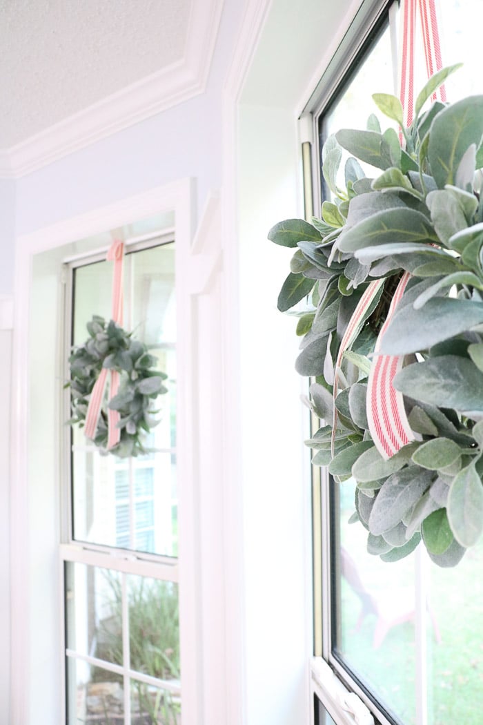 How to hang a wreath with ribbon on a window.  This simple DIY will show you two ways to hang wreaths on windows inside your home. 