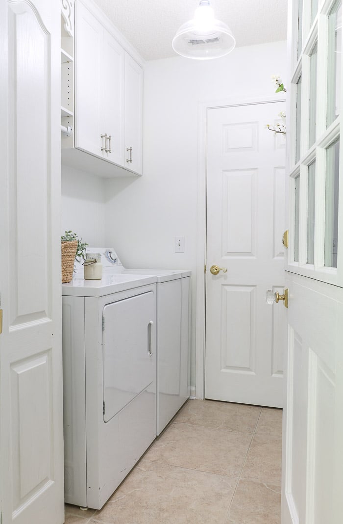 Small laundry room makeover using decorations, paint and a coat rack.