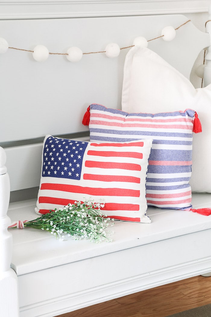 red, white and blue decorations in the entryway with American flag pillow