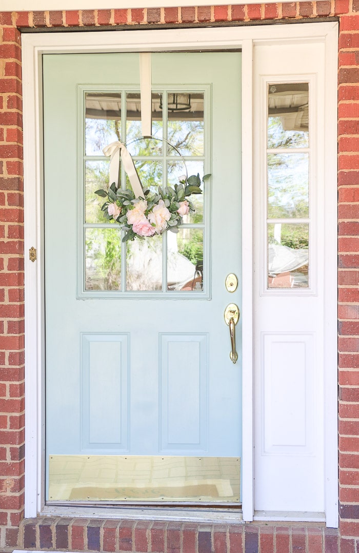 Best haint blue paint colors featuring Wythe Blue by Benjamin Moore on a front door porch