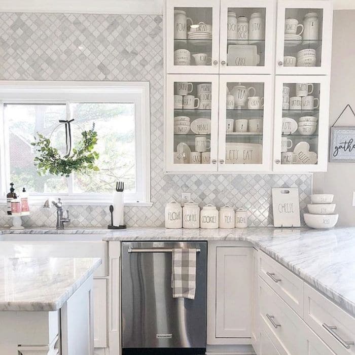 Farmhouse kitchen with glass doors by At Home With Jenna