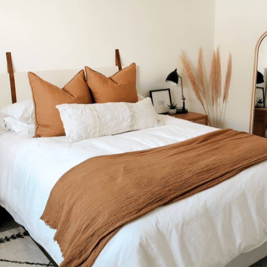 This DIY headboard utilizes leather straps to hand the headboard.