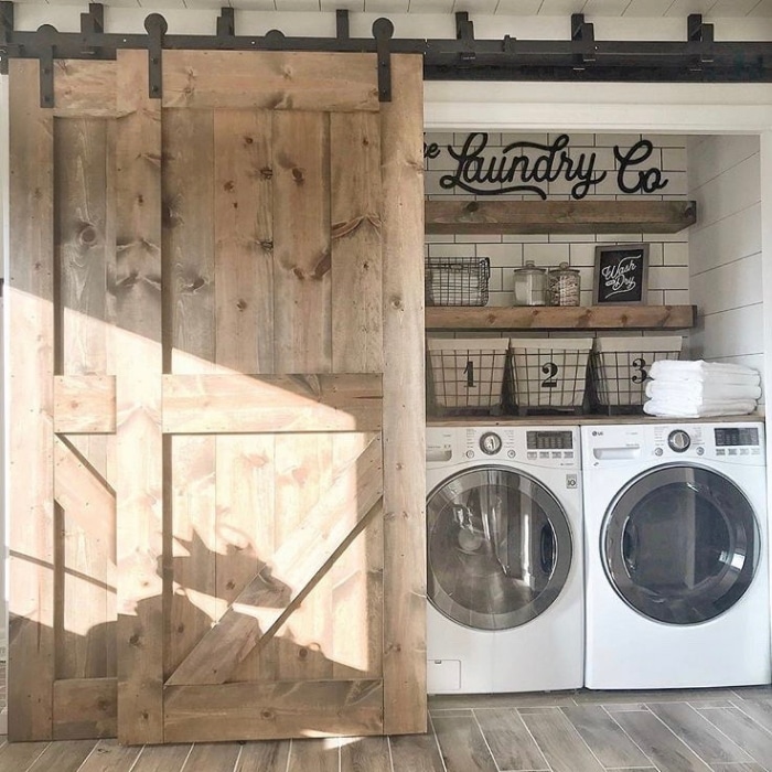 Farmhouse Laundry Room Decor by Fielderson Home with a sliding farm door and subway tiling
