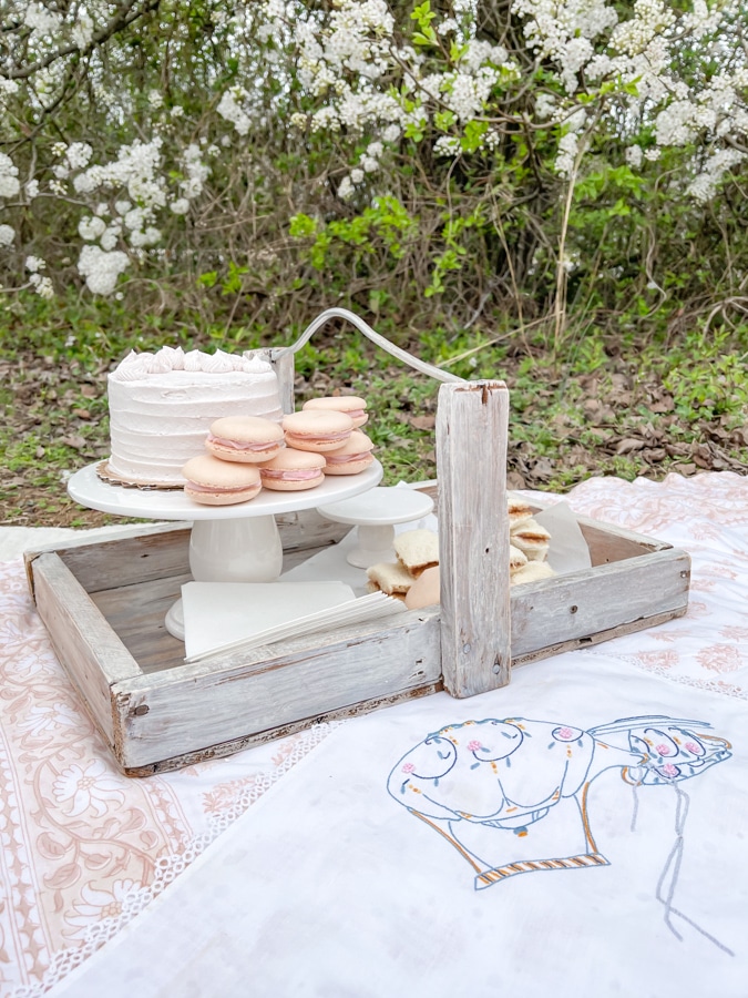 Setting up for a tea party picnic using a strawberry picking tray to serve on