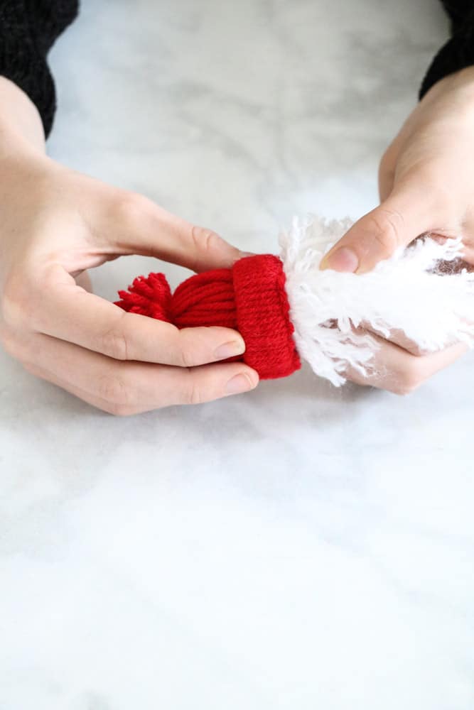 Attach beard to winter hat for yarn Santa garland